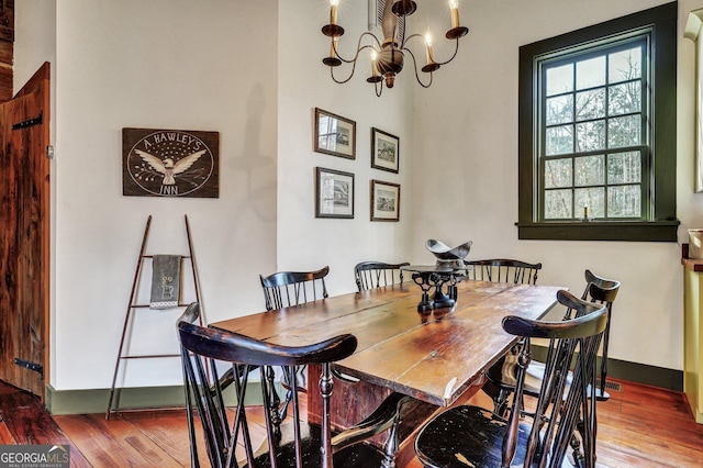 590 Dogwood Way, Richmond Hill, GA 31324 - dining room with baseboards, wood finished floors, and an inviting chandelier