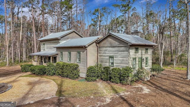 590 Dogwood Way, Richmond Hill, GA 31324 - view of home's exterior featuring metal roof and a chimney