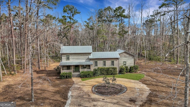 590 Dogwood Way, Richmond Hill, GA 31324 - view of front of property with a porch, metal roof, and a forest view