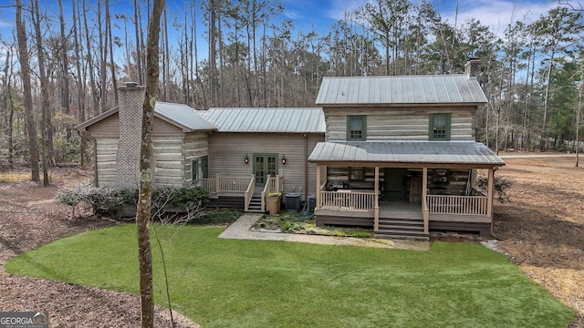 590 Dogwood Way, Richmond Hill, GA 31324 - rear view of house with a chimney, metal roof, a yard, and a wooden deck