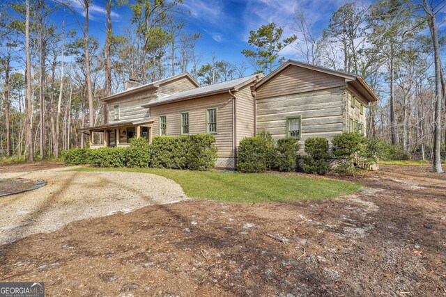 590 Dogwood Way, Richmond Hill, GA 31324 - view of side of home with a yard and a chimney