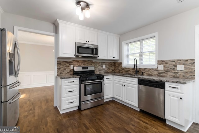 1650 Berryhill Rd, Cumming, GA 30041 - kitchen with dark stone counters, a sink, white cabinetry, and appliances with stainless steel finishes