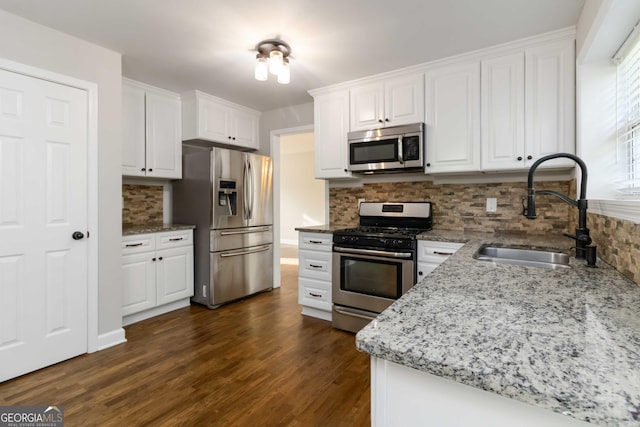 1650 Berryhill Rd, Cumming, GA 30041 - kitchen featuring white cabinets, stainless steel appliances, a sink, dark wood finished floors, and tasteful backsplash