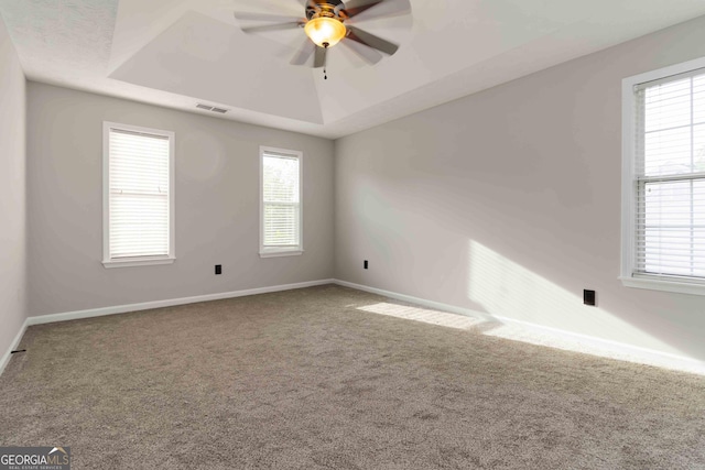 1650 Berryhill Rd, Cumming, GA 30041 - unfurnished room featuring a tray ceiling, visible vents, baseboards, carpet flooring, and ceiling fan