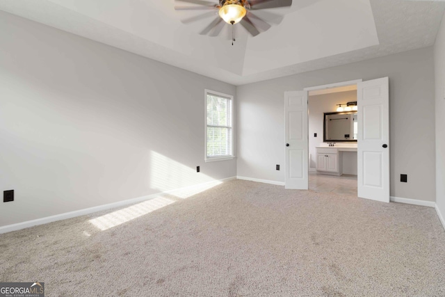 1650 Berryhill Rd, Cumming, GA 30041 - interior space featuring light carpet, a ceiling fan, baseboards, and a tray ceiling