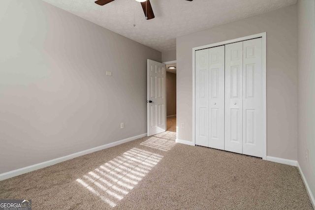 1650 Berryhill Rd, Cumming, GA 30041 - unfurnished bedroom with a ceiling fan, a textured ceiling, a closet, baseboards, and carpet flooring