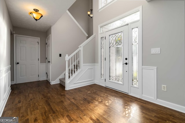 1650 Berryhill Rd, Cumming, GA 30041 - foyer entrance featuring wood finished floors, stairs, and a decorative wall