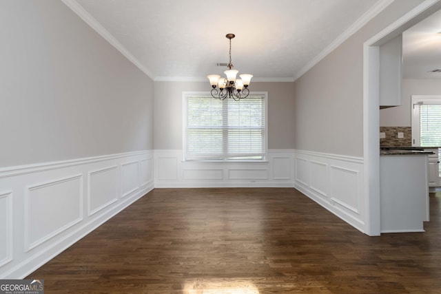 1650 Berryhill Rd, Cumming, GA 30041 - unfurnished dining area featuring a decorative wall, crown molding, wainscoting, a chandelier, and dark wood-type flooring