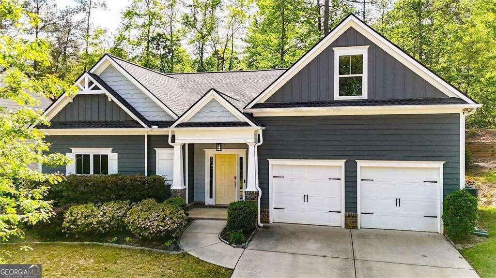 6859 Winding Wade Trl, Austell, GA 30168 - craftsman-style home with board and batten siding, driveway, and a garage