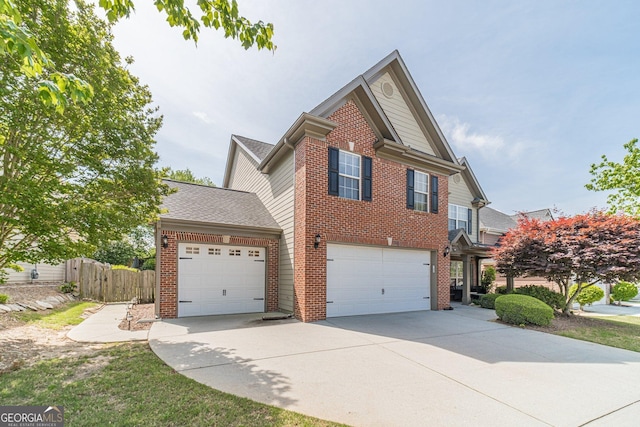 view of front of home featuring fence, brick siding, a garage, and concrete driveway