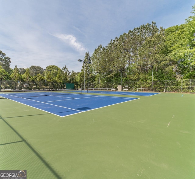 view of sport court with fence