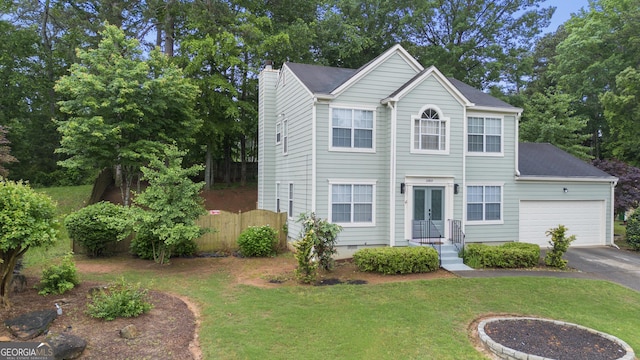 view of front of property with asphalt driveway, a chimney, a garage, and french doors