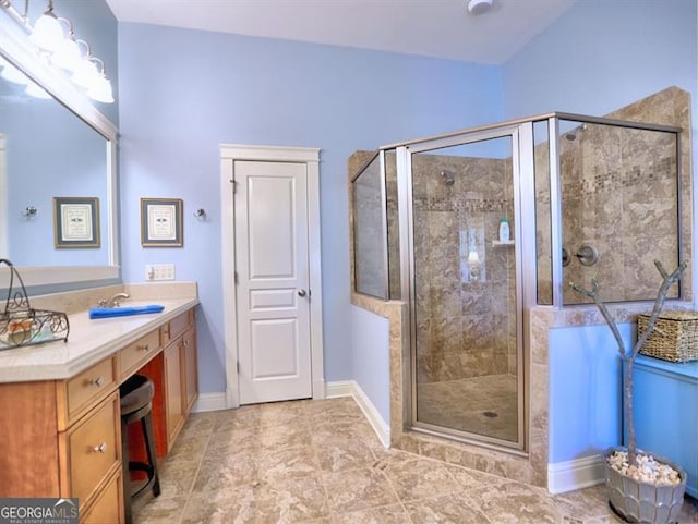 bathroom featuring a shower stall, vanity, and baseboards