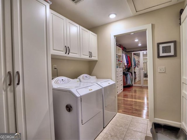 hall with wood finished floors, ornamental molding, a chandelier, baseboards, and an upstairs landing