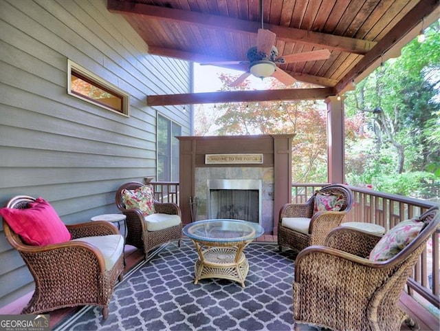 deck featuring a ceiling fan and an outdoor living space with a fireplace