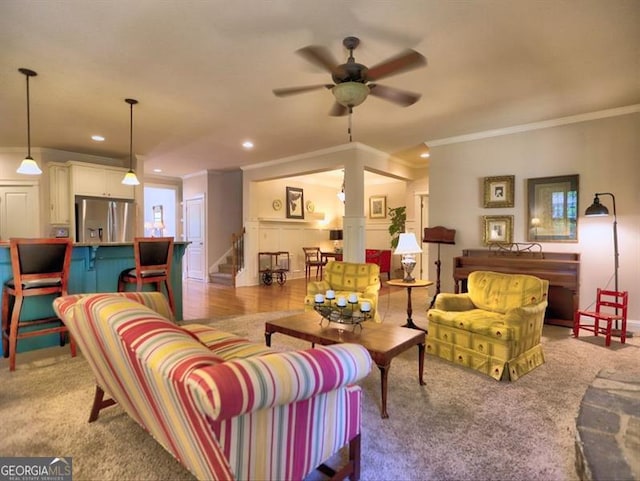 carpeted living room with ceiling fan, a fireplace, ornamental molding, baseboards, and recessed lighting
