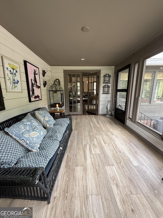 living room featuring wood walls and wood finished floors