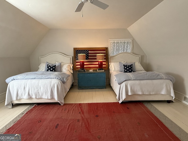 bedroom featuring vaulted ceiling, a ceiling fan, and wood finished floors