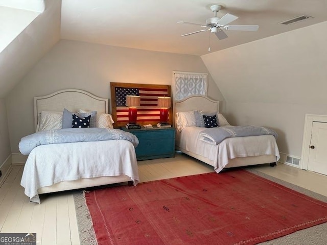 bedroom with ceiling fan, vaulted ceiling, and visible vents