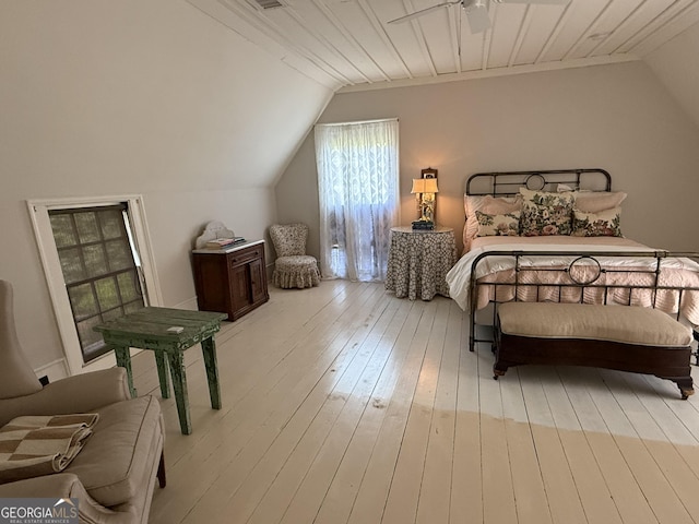 bedroom with vaulted ceiling and light wood-style flooring