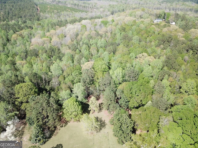 birds eye view of property featuring a wooded view