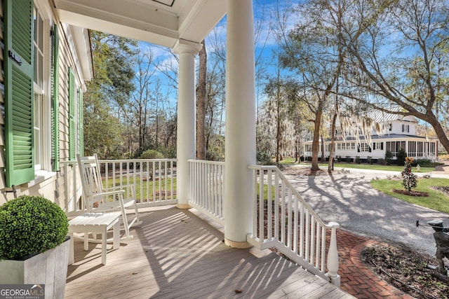192 Myrtle Grove Ln, Richmond Hill, GA 31324 - wooden deck with a porch