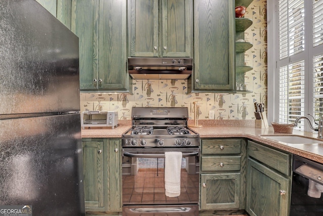 192 Myrtle Grove Ln, Richmond Hill, GA 31324 - kitchen with a sink, green cabinets, black appliances, ventilation hood, and wallpapered walls