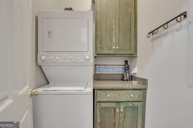 192 Myrtle Grove Ln, Richmond Hill, GA 31324 - washroom featuring stacked washing maching and dryer and cabinet space