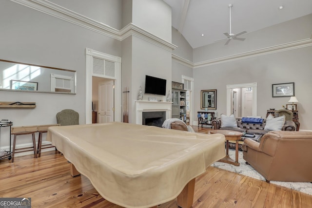 192 Myrtle Grove Ln, Richmond Hill, GA 31324 - game room featuring a fireplace, light wood-style floors, ceiling fan, and high vaulted ceiling