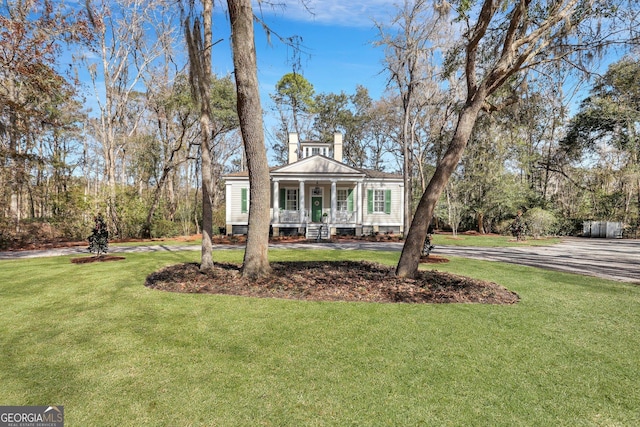 192 Myrtle Grove Ln, Richmond Hill, GA 31324 - greek revival inspired property with a porch and a front lawn