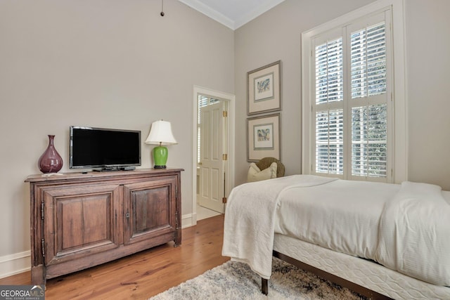 192 Myrtle Grove Ln, Richmond Hill, GA 31324 - bedroom featuring crown molding, light wood finished floors, and baseboards