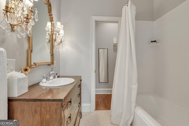 192 Myrtle Grove Ln, Richmond Hill, GA 31324 - full bath featuring tile patterned floors, shower / bath combo with shower curtain, and vanity