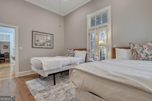 192 Myrtle Grove Ln, Richmond Hill, GA 31324 - bedroom featuring wood-type flooring, crown molding, access to exterior, and baseboards