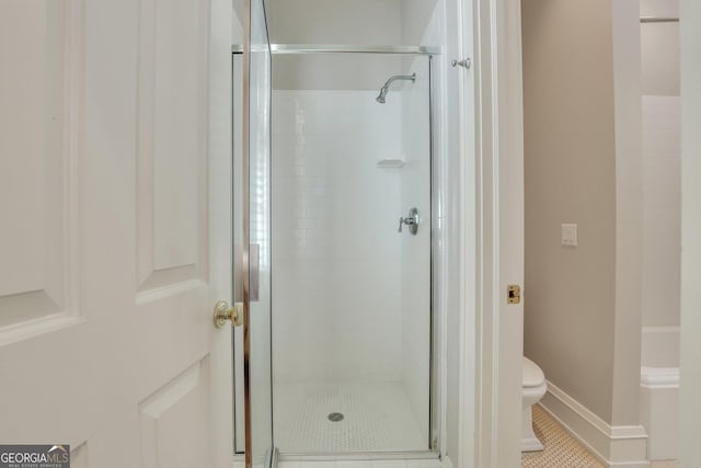 192 Myrtle Grove Ln, Richmond Hill, GA 31324 - bathroom with baseboards, a shower stall, toilet, and tile patterned flooring