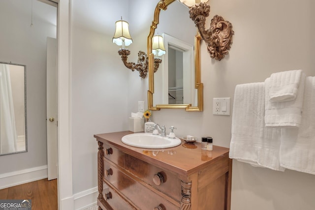 192 Myrtle Grove Ln, Richmond Hill, GA 31324 - bathroom with wood finished floors, vanity, and baseboards