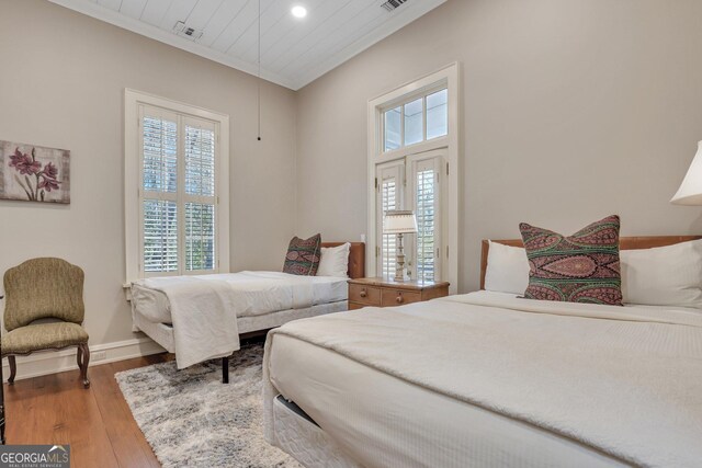 192 Myrtle Grove Ln, Richmond Hill, GA 31324 - bedroom with wood finished floors, crown molding, baseboards, and multiple windows