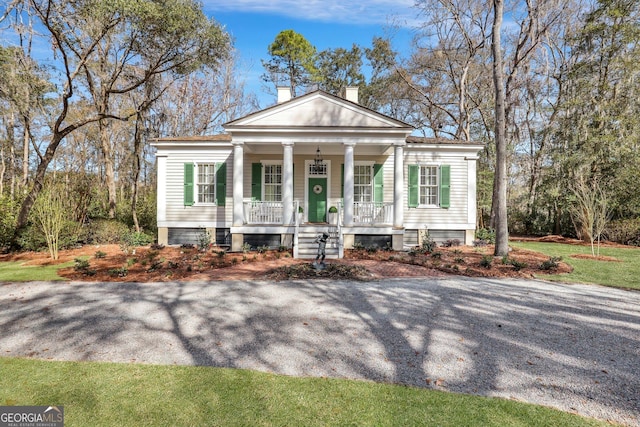 192 Myrtle Grove Ln, Richmond Hill, GA 31324 - neoclassical / greek revival house with covered porch and a chimney