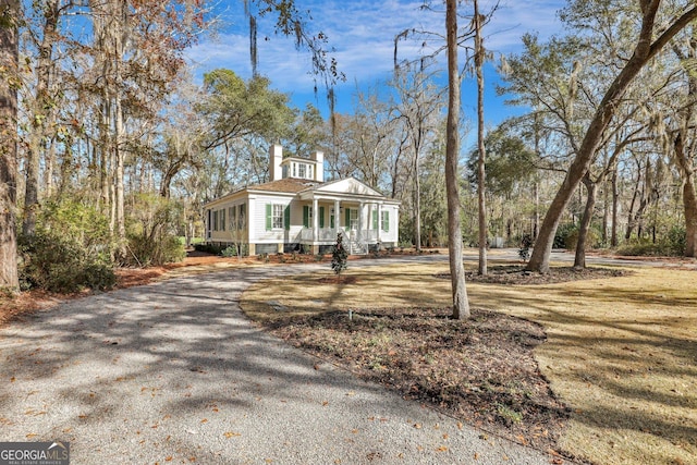 192 Myrtle Grove Ln, Richmond Hill, GA 31324 - view of front of home featuring aphalt driveway and a porch