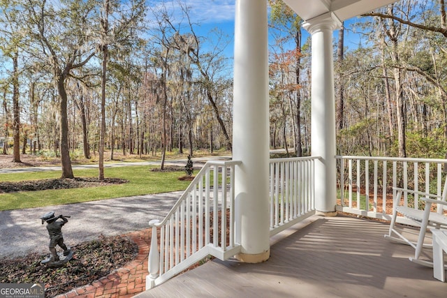 192 Myrtle Grove Ln, Richmond Hill, GA 31324 - wooden deck featuring covered porch