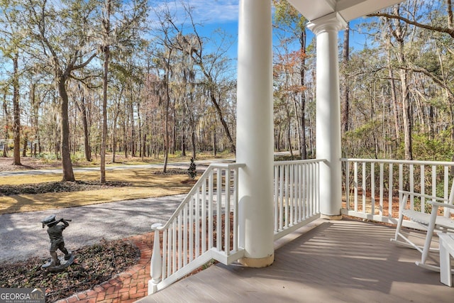 192 Myrtle Grove Ln, Richmond Hill, GA 31324 - wooden deck featuring a porch