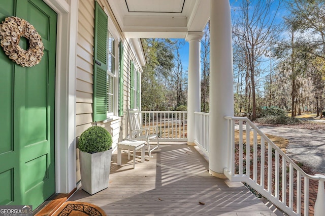 192 Myrtle Grove Ln, Richmond Hill, GA 31324 - wooden deck with covered porch