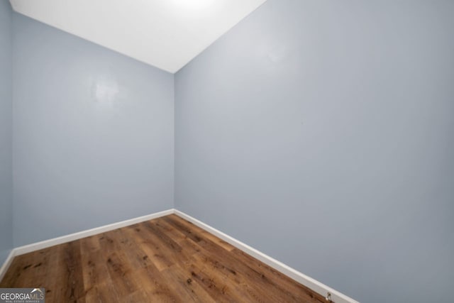 548 Myrtle Trace Ln, Suwanee, GA 30024 - unfurnished room featuring baseboards and wood finished floors