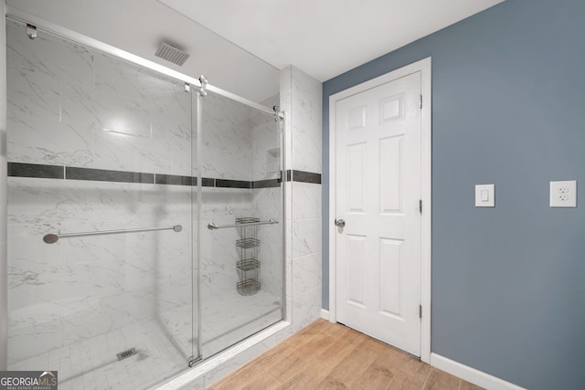 548 Myrtle Trace Ln, Suwanee, GA 30024 - full bath with a marble finish shower and wood finished floors