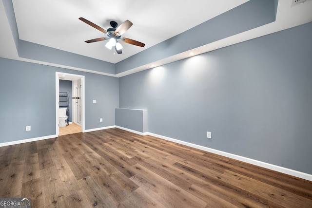 548 Myrtle Trace Ln, Suwanee, GA 30024 - unfurnished room featuring ceiling fan, wood finished floors, and a tray ceiling
