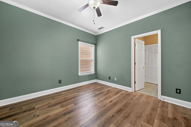 548 Myrtle Trace Ln, Suwanee, GA 30024 - unfurnished bedroom featuring ornamental molding, wood finished floors, and ceiling fan