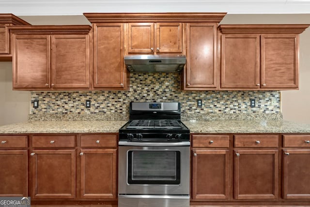 548 Myrtle Trace Ln, Suwanee, GA 30024 - kitchen with gas stove, under cabinet range hood, decorative backsplash, and light stone countertops
