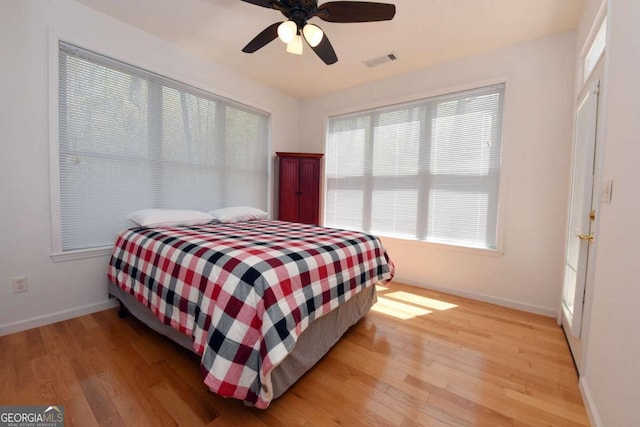 62 Eagles View Ct, Hayesville, NC 28904 - bedroom with baseboards, light wood-style flooring, multiple windows, and a ceiling fan