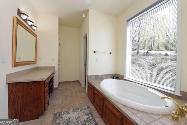 62 Eagles View Ct, Hayesville, NC 28904 - bathroom with healthy amount of natural light, a bath, vanity, and stone finish floors
