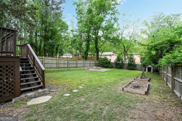 360 New Jersey Ave NW, Atlanta, GA 30314 - view of yard featuring a shed, stairway, a deck, a garden, and an outbuilding
