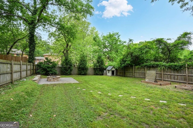 360 New Jersey Ave NW, Atlanta, GA 30314 - view of yard featuring a fire pit, a patio area, a storage unit, and an outdoor structure